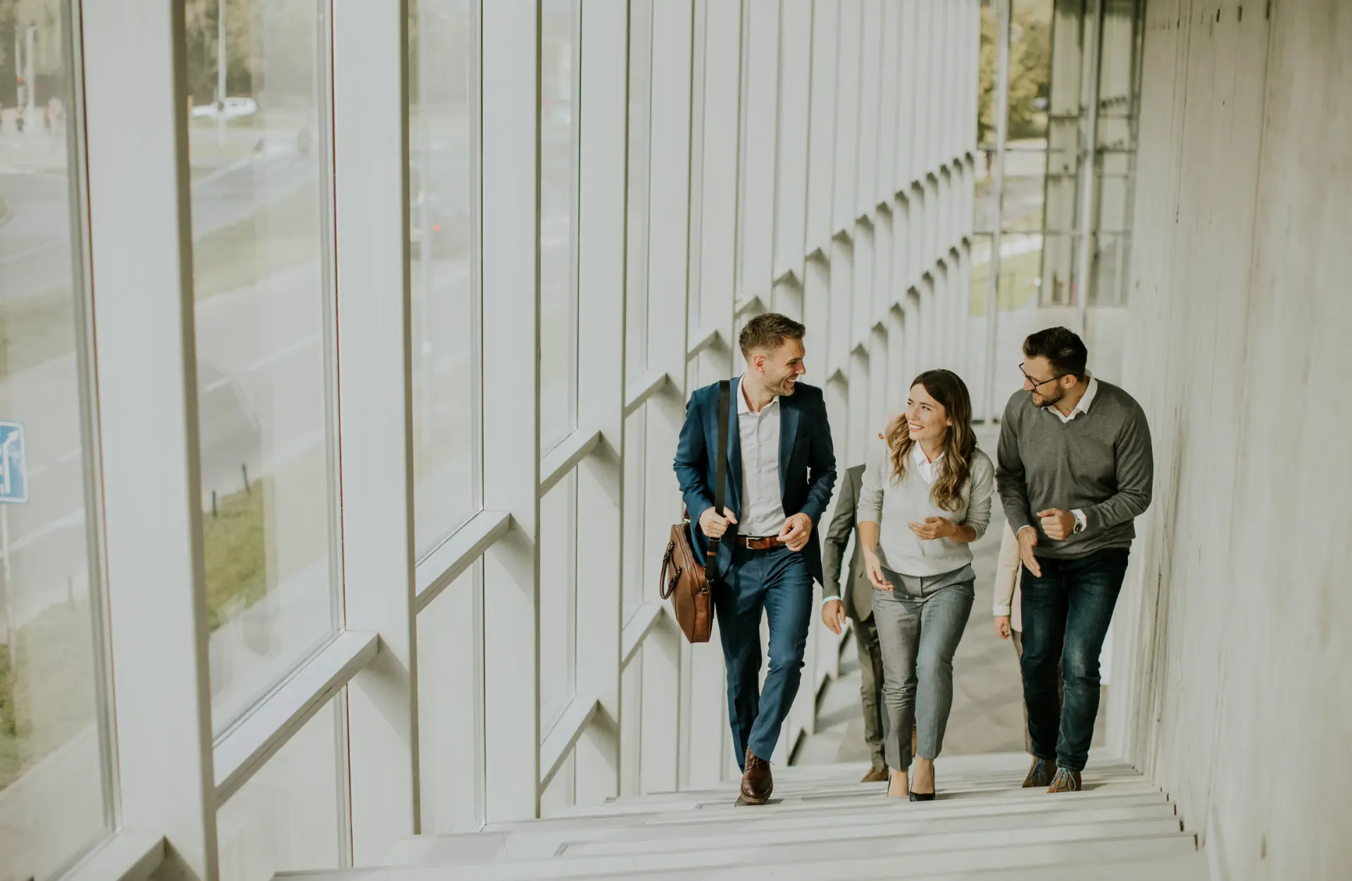 Legal professionals walking up a modern office staircase